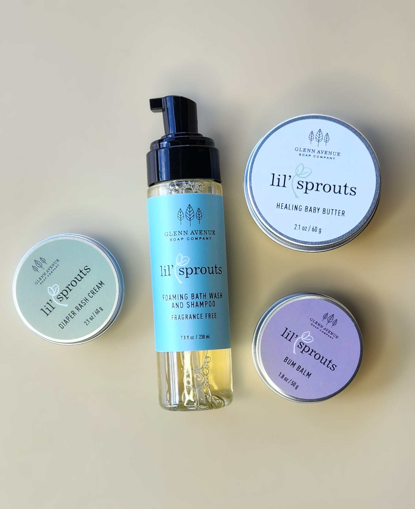 Collection of Lil' Sprouts baby care products on a beige background